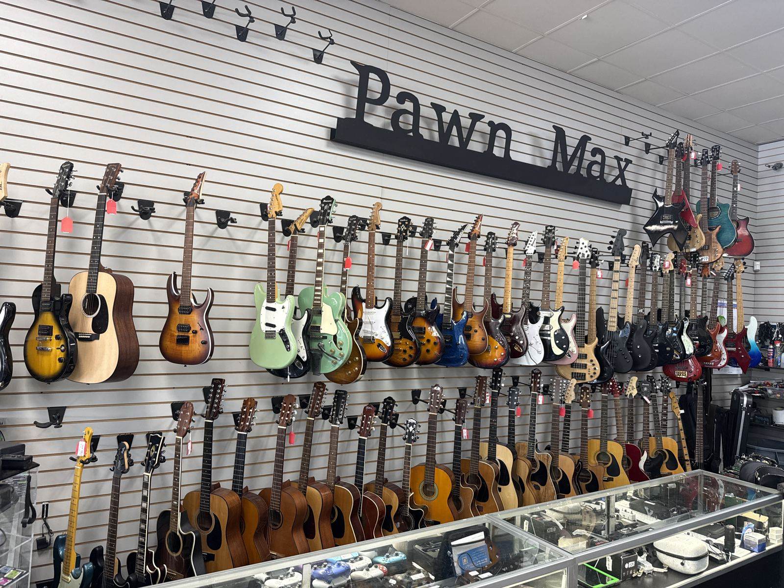 Wall of guitars under the Pawn Max sign