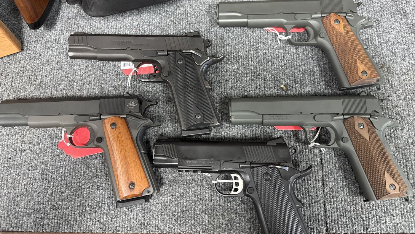 Five 1911 pistols on display