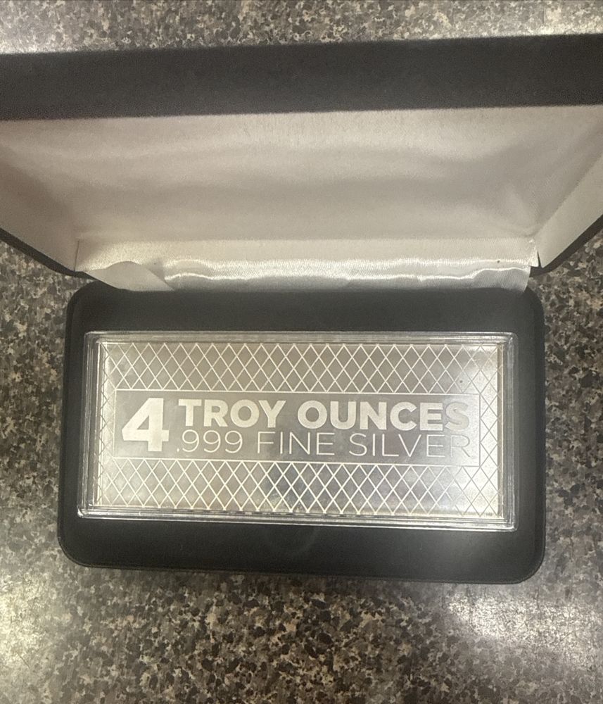 4 troy ounce .999 fine silver bar in a black presentation box
